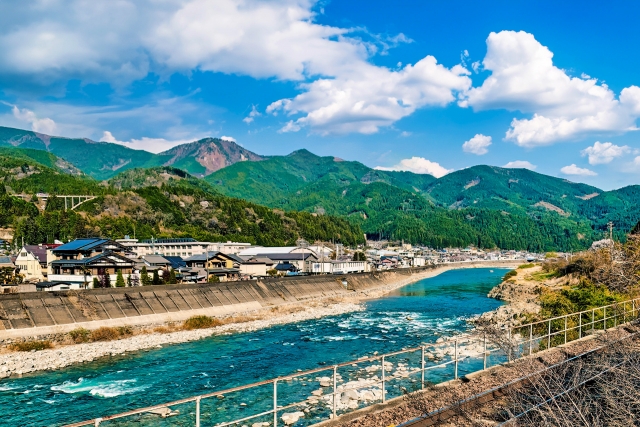 Gero Onsen - Gero Onsen: Discover One of Japan’s Top 3 Hot Springs Scenic view of Hida River flowing through Gero Onsen with mountains in the background.