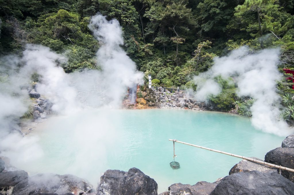 Beppu Onsen famous Umi Jigoku with steaming turquoise waters.