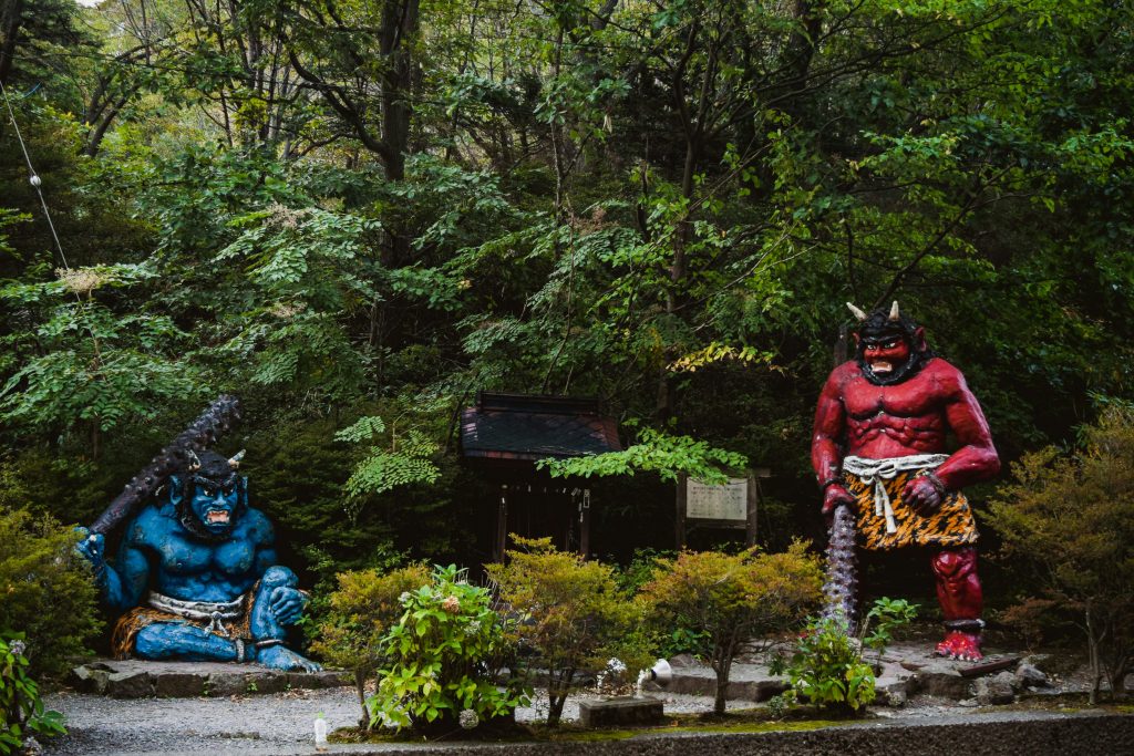 Noboribetsu Onsen - Noboribetsu Onsen Travel Guide | Best Hot Springs in Hokkaido Noboribetsu Onsen Colorful red and blue oni statues welcoming visitors in a lush forest setting