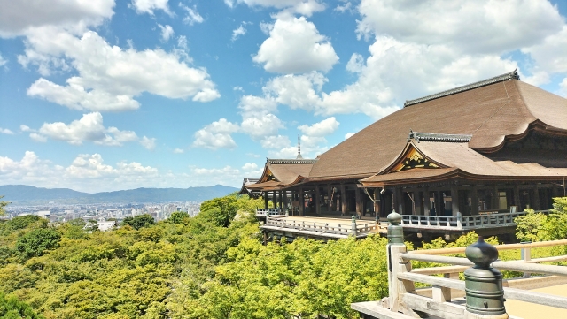 Kyoto’s Historic Heart – Kiyomizu-dera Temple overlooking the city and forest under a bright blue sky