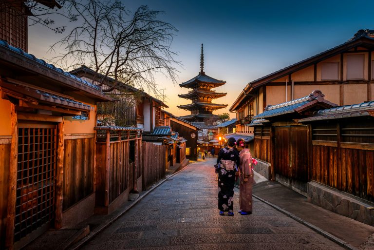 Kyoto’s Historic Heart – Traditional wooden townhouses leading to Yasaka Pagoda at dusk